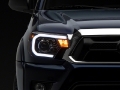 Picture of Raxiom 12-15 Toyota Tacoma Axial Projector Headlights w- SEQL LED Bar- Blk Housing Clear Lens